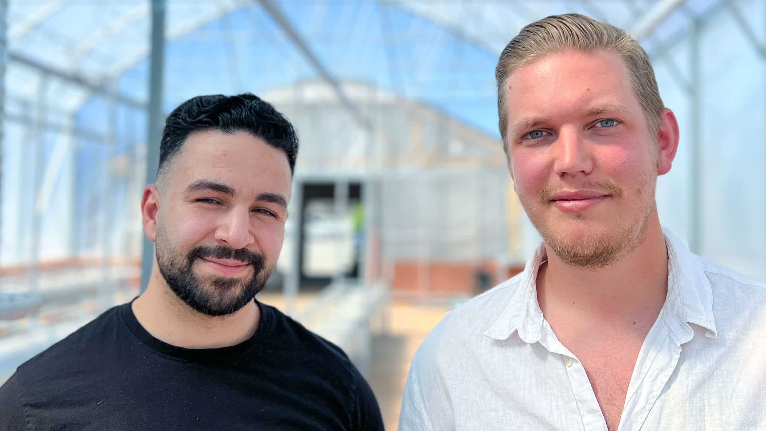 Hamza Qadoumi, CEO of Ecobloom, and Manne Ek, gardeners in the greenhouse, are standing inside of the greenhouse.