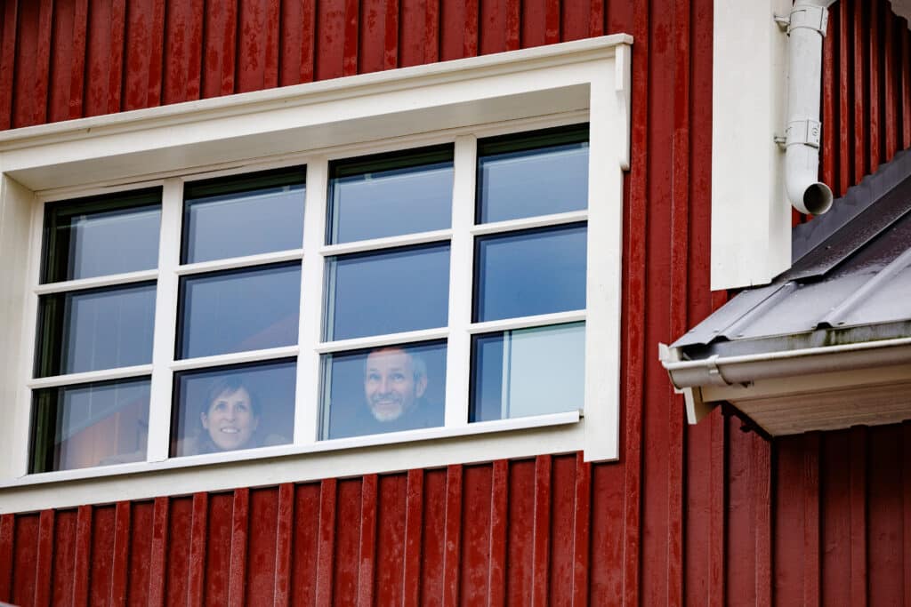 Two people looking out of a window