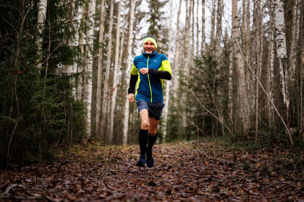 Iain Bramble jumps in the forest